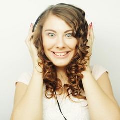Fototapeta premium Young curly woman with headphones listening music.