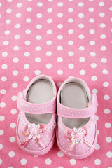 Baby shoes on cloth background