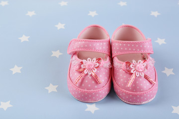 Baby shoes on blue background