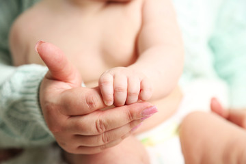 Baby hand in mother hand, close-up