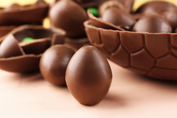 Chocolate Easter eggs on wooden table, closeup