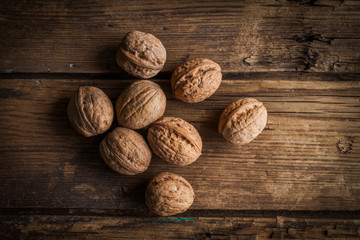 whole walnuts on old wooden table