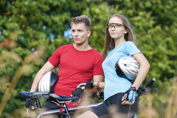 Obraz premium Two Young Caucasian Professional Cyclists Together with Their Bi