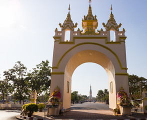 The view of white pagoda of Pratart Phanom temple from the arch