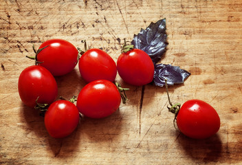 tomatoes on a wooden board with basil