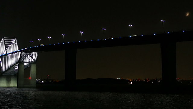 Transportation surrounding the illuminated Tokyo Gate Bridge