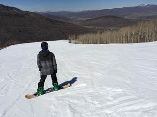 Snowboarder on Temptation Trail in Park City, Utah
