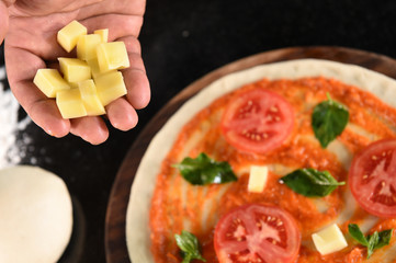 pizza and ingredients for pizza on wooden background