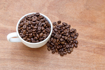 Cup of coffee. View from above on a wooden surface.
