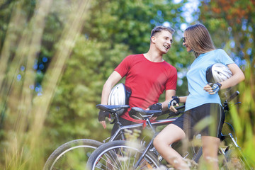 Two Professional Cycling Athletes Standing Together Outdoors wit