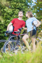 Two Young Caucasian Professional Cyclists Together with Their Bi