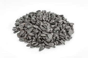 Sunflower seeds pile against white background