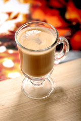 glass of latte macchiato coffe on wooden table