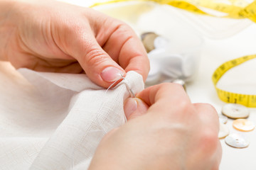 Sewing moment: inserting the needle in fabric