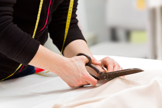 Woman With Tailor Scissors Cutting Out Fabric 38, People Stock