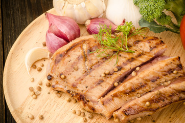 Grilled pork (Pork steak) on wooden plate