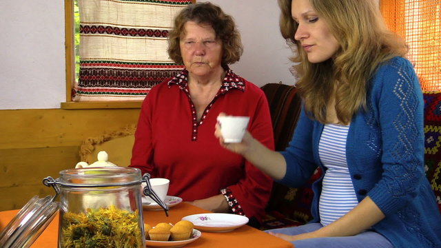 tea time cupcake in village room, woman give grandmother sugar