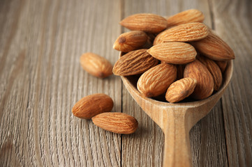 Almonds in wooden spoon