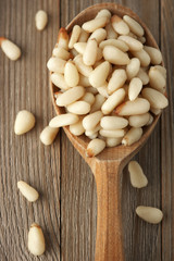 Pine nuts in wooden spoon