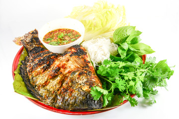 Tilapia grilled with  vegetable isolate on white