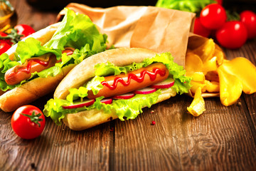 Hot dog. Grilled hot dogs with ketchup on a wooden table