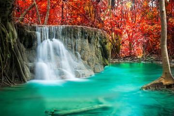 Fototapeta na wymiar Beautiful waterfall in autumn forest 