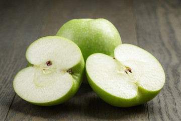 green sour apple on wood table sliced