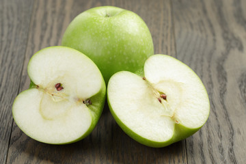 green sour apple on wood table sliced