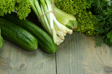 collection of green vegetables on a wooden background