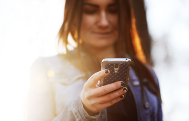 Girl dials sms message on mobile phone