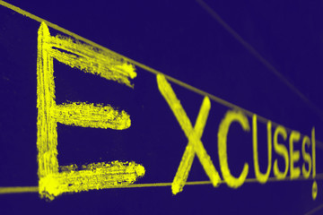 excuses word handwritten on black chalkboard