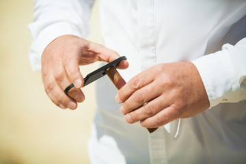 Obraz na płótnie Canvas Man Cutting a Cigar