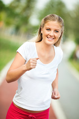 Fototapeta premium Happy young woman jogging