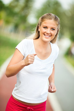 Happy young woman jogging