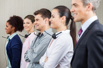 Fototapeta na wymiar Smiling Customer Service Representative Standing With Colleagues