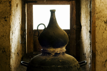 traditional alembic distiller with window in old adobe  house © GDM photo and video