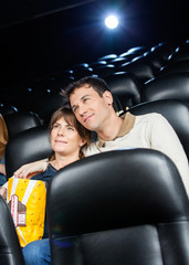 Naklejka premium Affectionate Couple Watching Film In Theater
