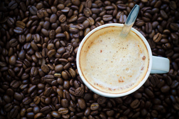 coffee cup on coffee bean background