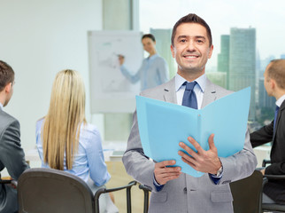 happy businessman with open folder