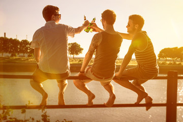 Three friends drinking beer