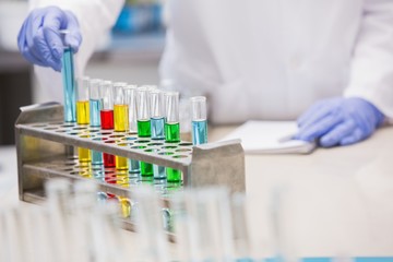 Scientist examining tubes