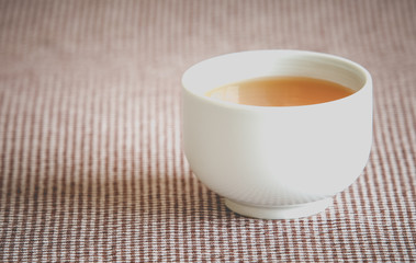 A cup of hot chinese tea on table