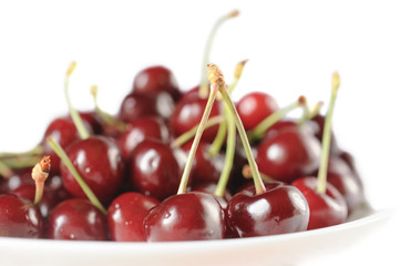 Sweet cherry in a bowl isolated on white