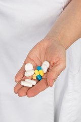 Pills, tablets and drugs heap in doctor hand,