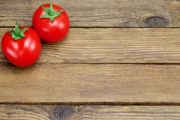 Two Ripe Tomatoes On Rustic Wood Background