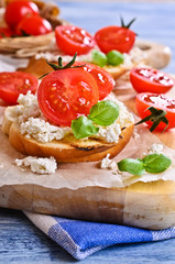 Fototapeta na wymiar Sandwich with cheese, tomato and Basil