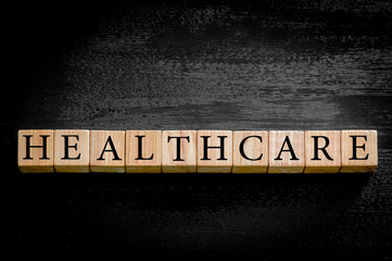 Word HEALTHCARE isolated on black background