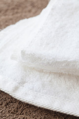 White clean towel on brown towel background