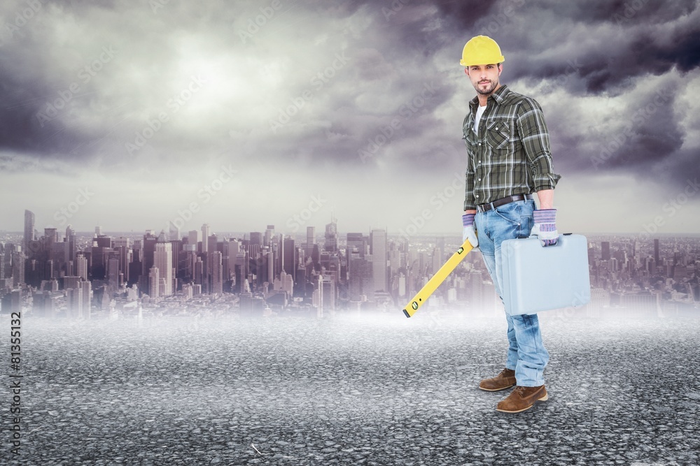 Poster Composite image of manual worker with spirit level and toolbox