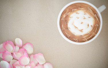 a cup of latte art on brown paper background